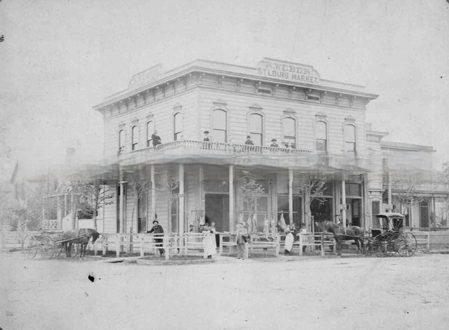 Twelve persons pose in front of Rudolph Weber's St. Louis Market at 1030 H Street (southwest corner of 11th and H Streets)., 1885