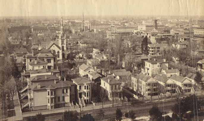 Five aerial views of Sacramento taken from the dome of the State Capitol, combined giving a panoramic view of Sacramento north of L Street, 1884