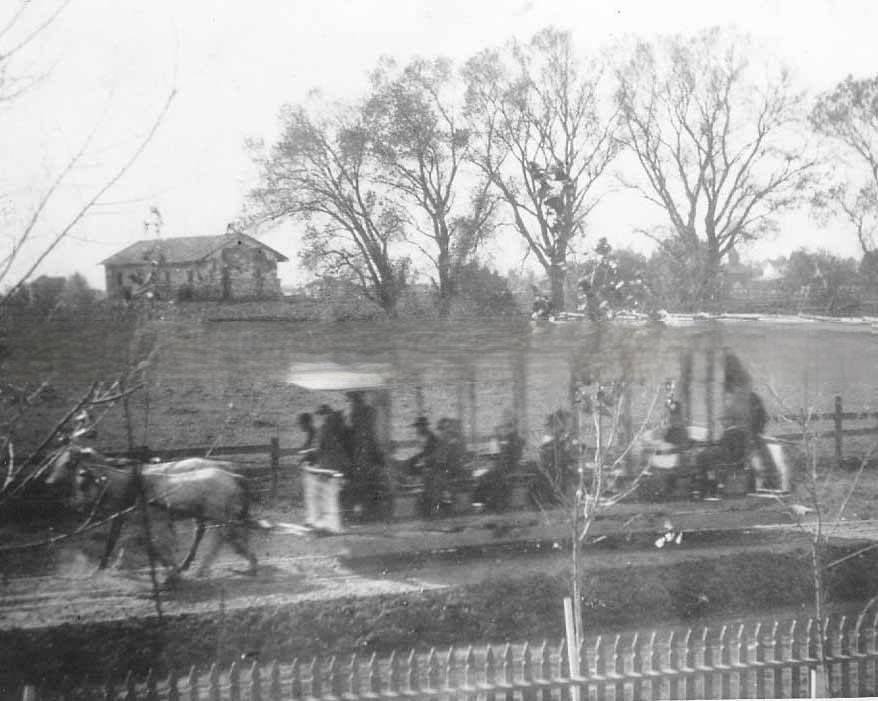 Horse-drawn street car going by Sutter's Fort central building, 1889