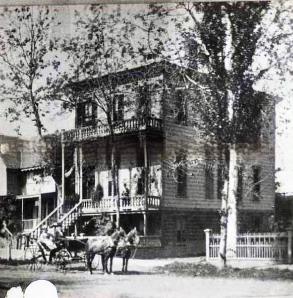 Two story home with a horse and buggy in front, 1880s