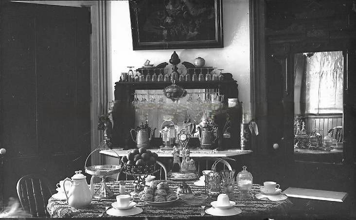 View of dining table and buffet set with tea, scones, and fruit, 1888