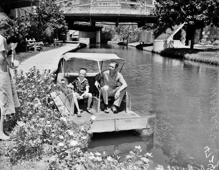 John H. Warren and son Bill in a paddle boat on San Antonio River, 1956