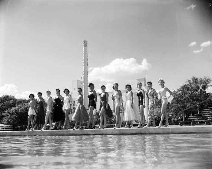Young women, in swim suits, on boardwalk on lake at Lone Star Brewing Company, 1954