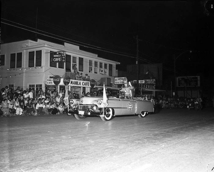 Fiesta Flambeau: King Antonio XXXII (John H. Savage Jr.) passes the Manila Café on Broadway, 1954