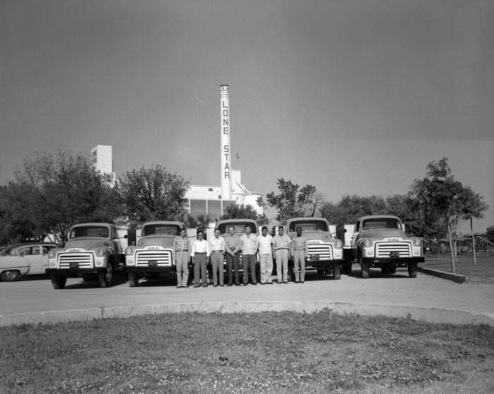 Employees in front of trucks at Lone Star Brewing Company, 542 Simpson Street, 1954