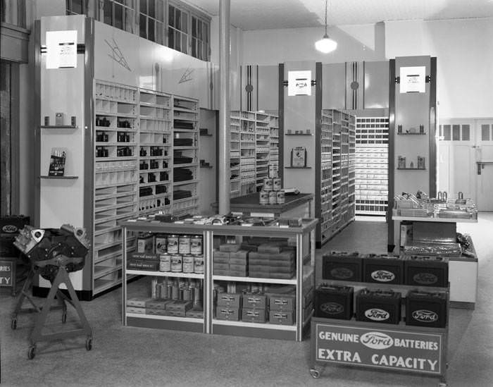 Ford Motor Company products in automotive parts display room, 1950s