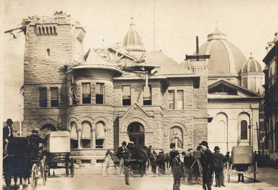San Jose Post office after earthquake with photographers and other people looking at the building and surrounds, 1906