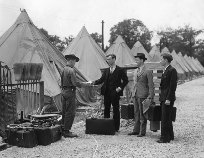 Men in suits visit a man with either long legs or short pants, 1937