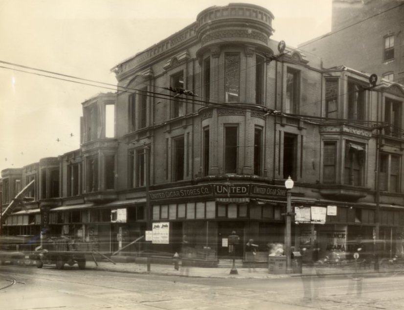 The three-story building that has stood at the southeast corner of Grand boulevard and Olive street for almost sixty years is being torn down to make way for a new two or three story structure, 1933