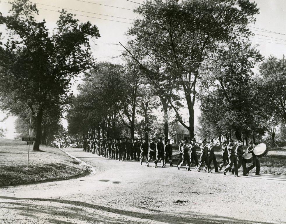 Army men are being lead by bass drummers of a marching band, 1939