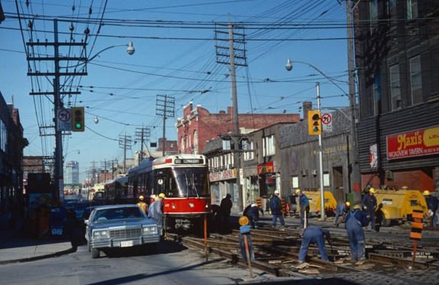 Streetcars continue to operate at Queen and Broadview despite track work (Broadview Hotel is "Maxi's,") March 25, 1981