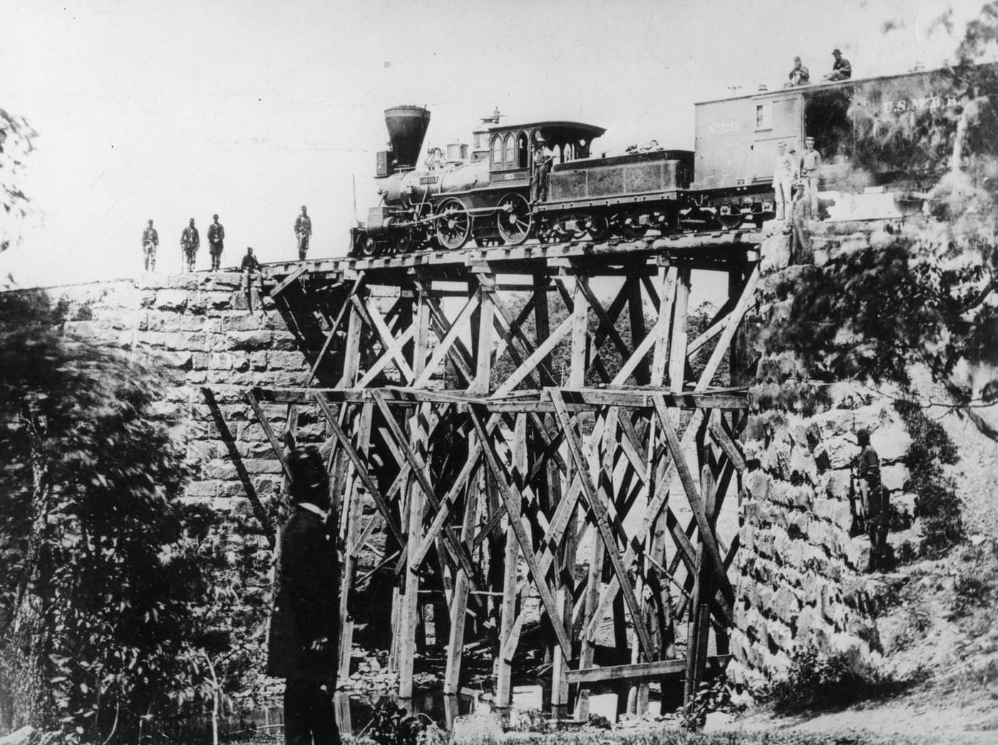 Steam locomotive 'Fire Fly', used by Union troops, on a narrow field bridge of the Orange and Alexandria US Military Railroad, 1865
