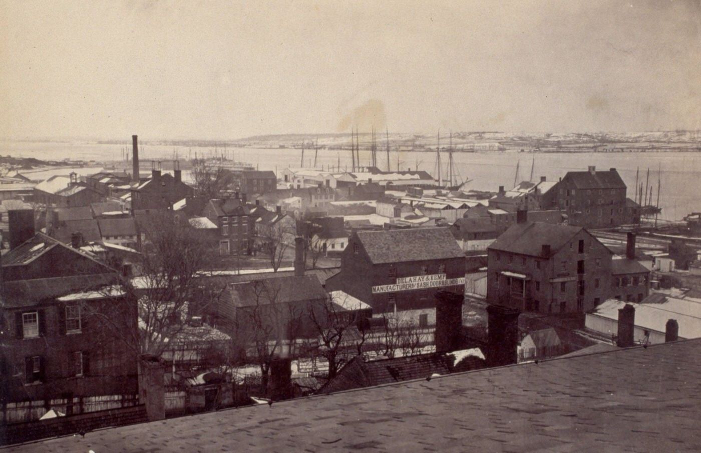 A winter view of Alexandria, Virginia, with Washington visible across the Potomac River, 1864