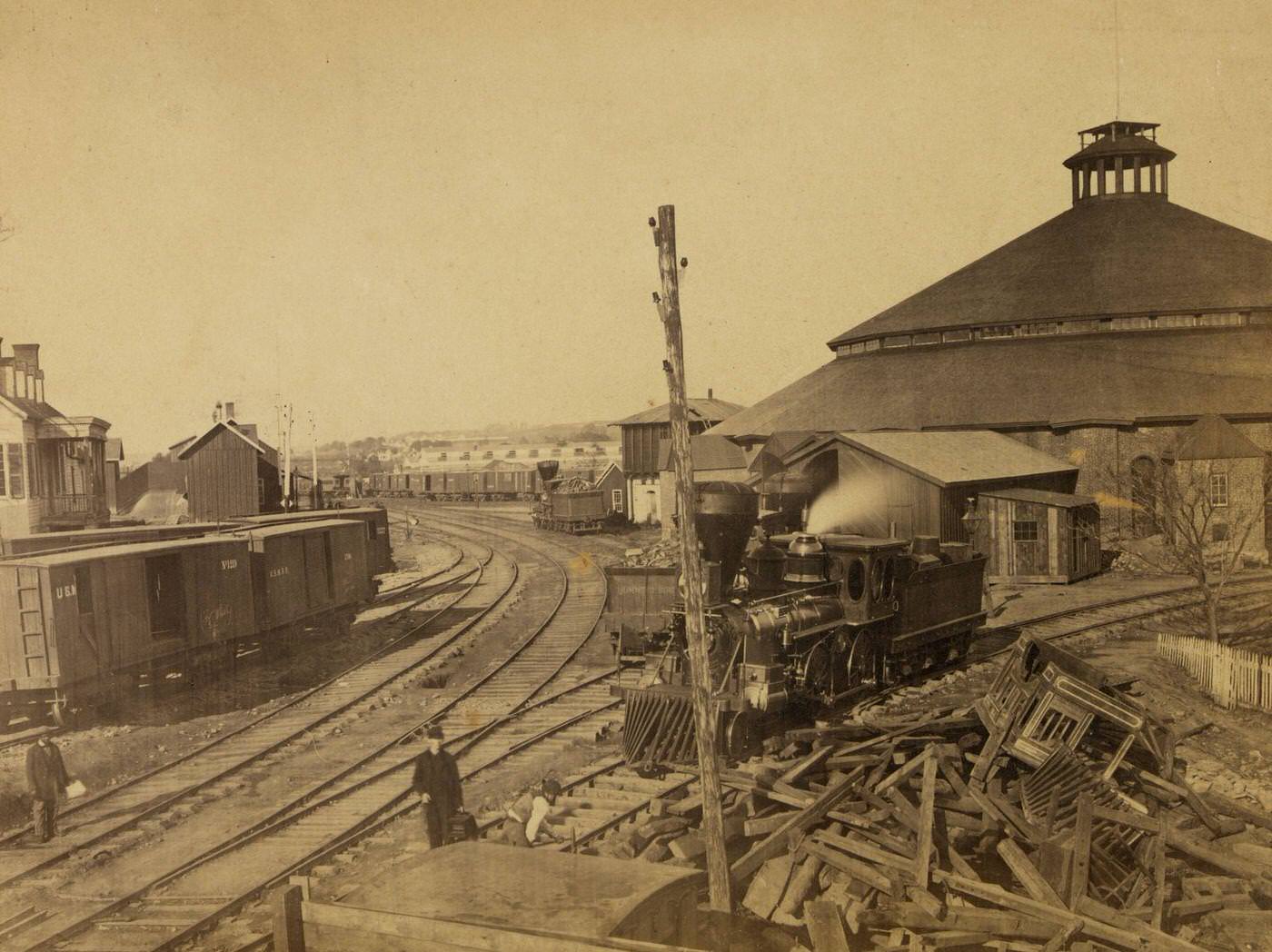 Locomotive moving away from the roundhouse at the Orange & Alexandria railroad yard in Alexandria, Virginia, 1863