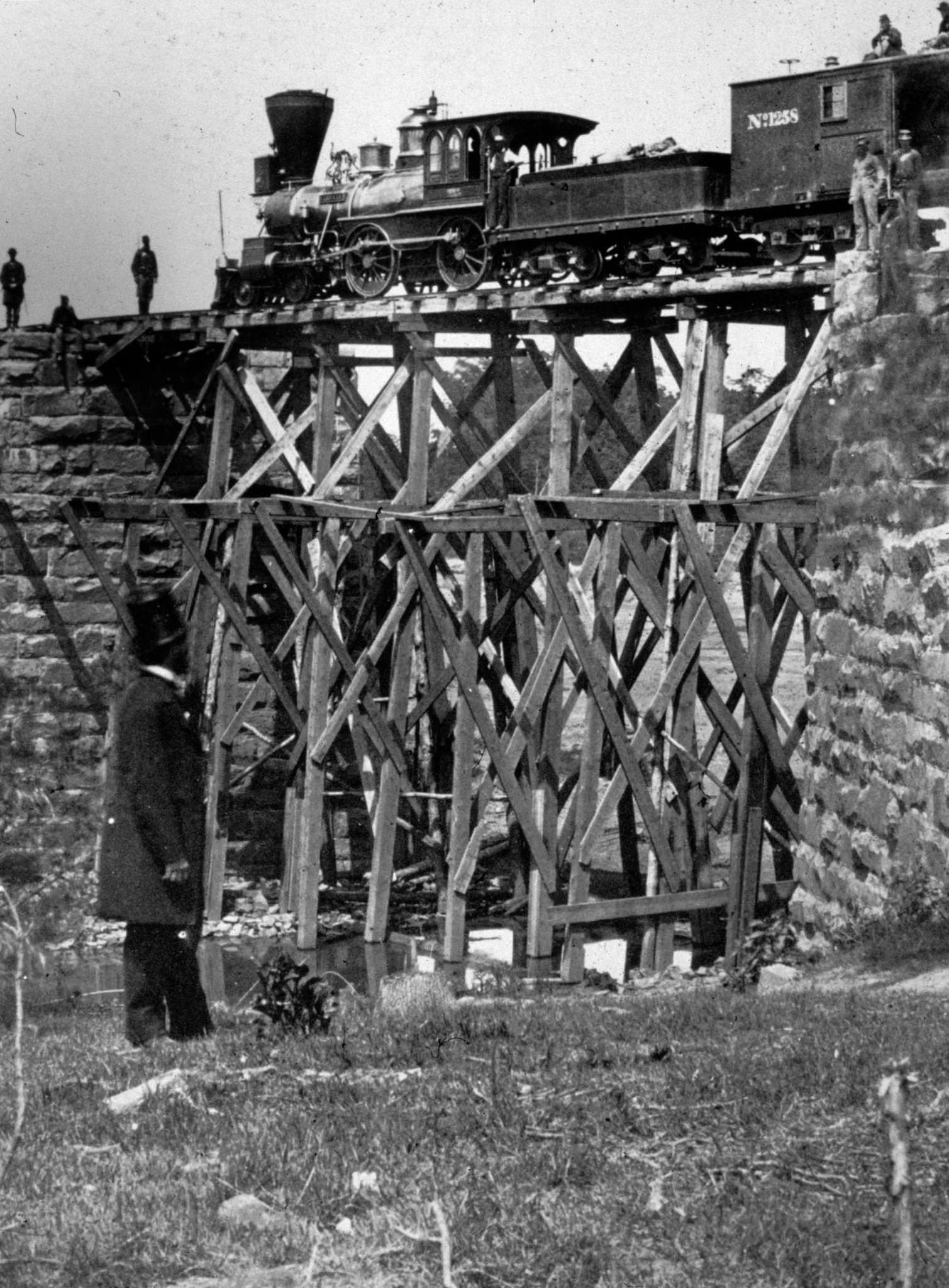 The 'Firefly' railroad engine crossing a river on a trestle, a narrow field bridge of the Orange and Alexandria US Military Railroad, 1863