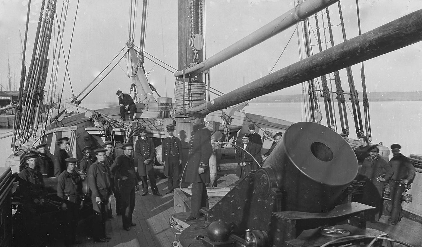 Group portrait of the crew, and a mortar gun, of an unidentified Union gunboat in port, Alexandria, Virginia, 1860s.