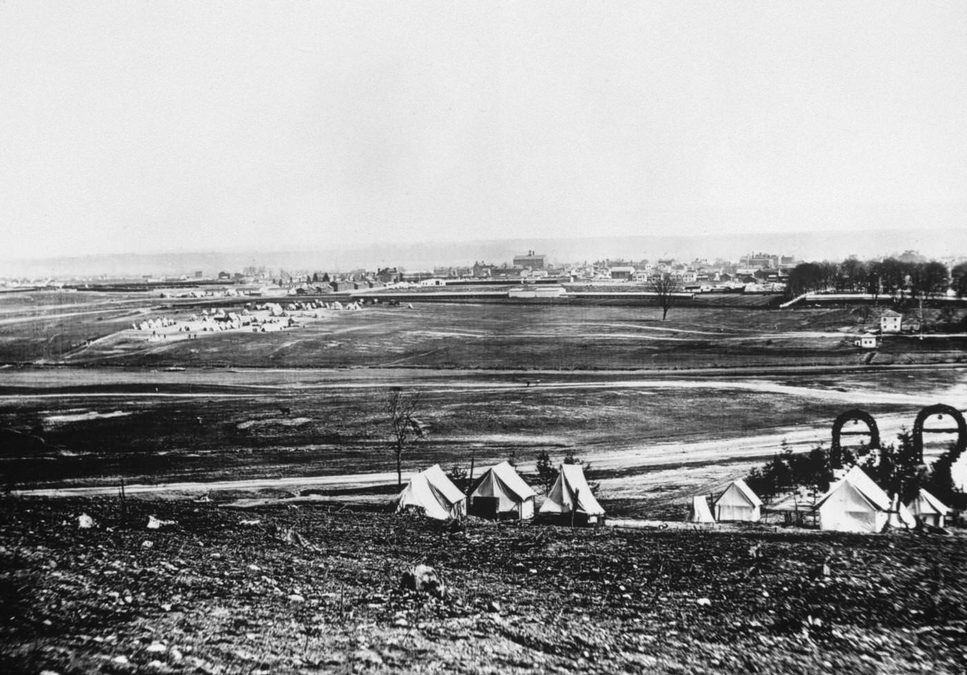 View of Alexandria, Virginia, tents of the 44th New York Infantry in foreground during the US civil war. Alexandria was captured by the Union in 1861.