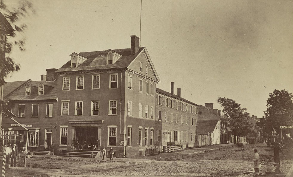 A group of people in front of the Marshall House at the corner of King and St. Asaph Streets, Alexandria, 1863