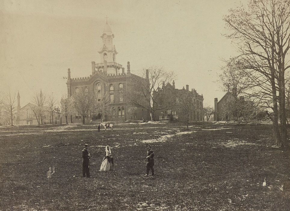A woman with two Union soldiers in front of the seminary which was headquarters for the Army of the Potomac, 1862