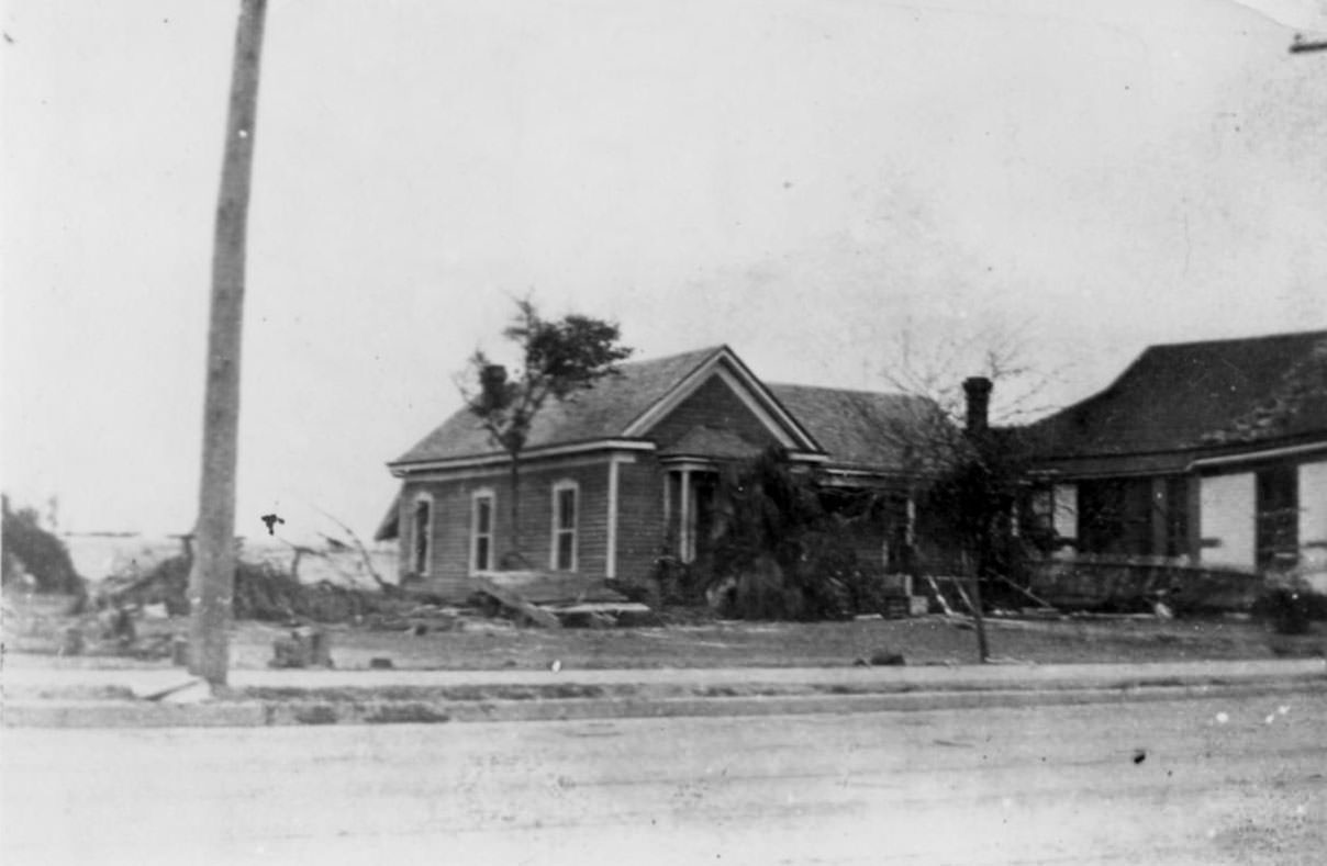 Two homes with a sand bank behind them after the hurricane of 1919 in Corpus Christi.