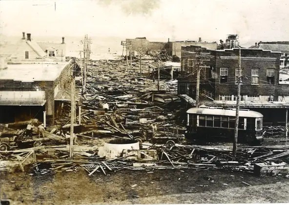 Looking down Laguna Street toward Corpus Christi Bay following the Sept. 14, 1919 hurricane. The streetcar is on Mesquite Street. Laguna Street is now John Sartain Street.