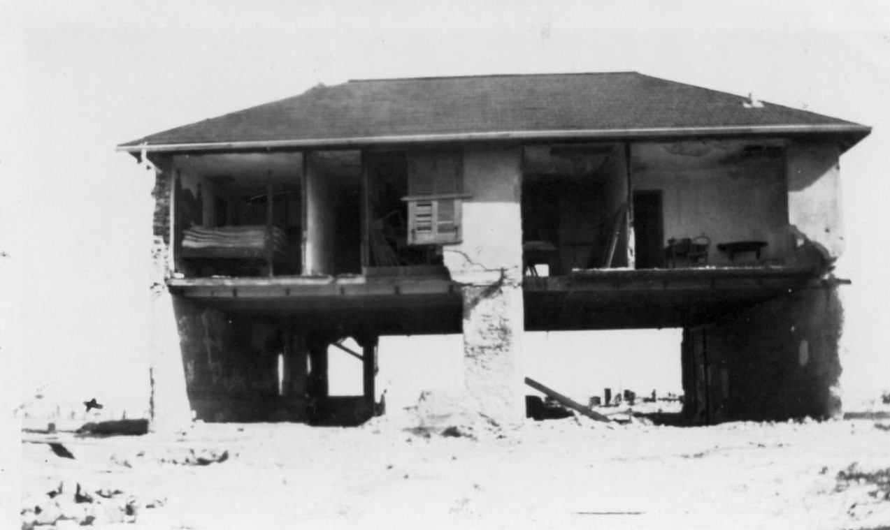 A two-story house whose front walls are missing.