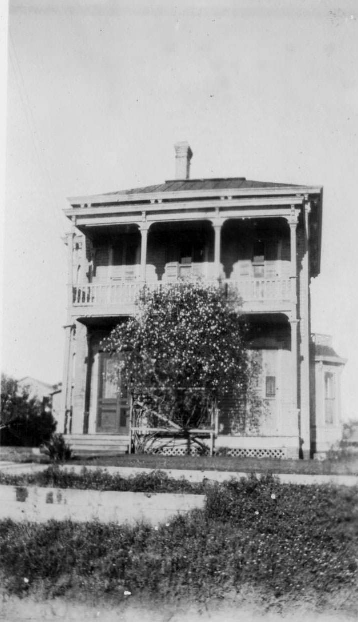 A two-story home with large porch and balcony on the front.