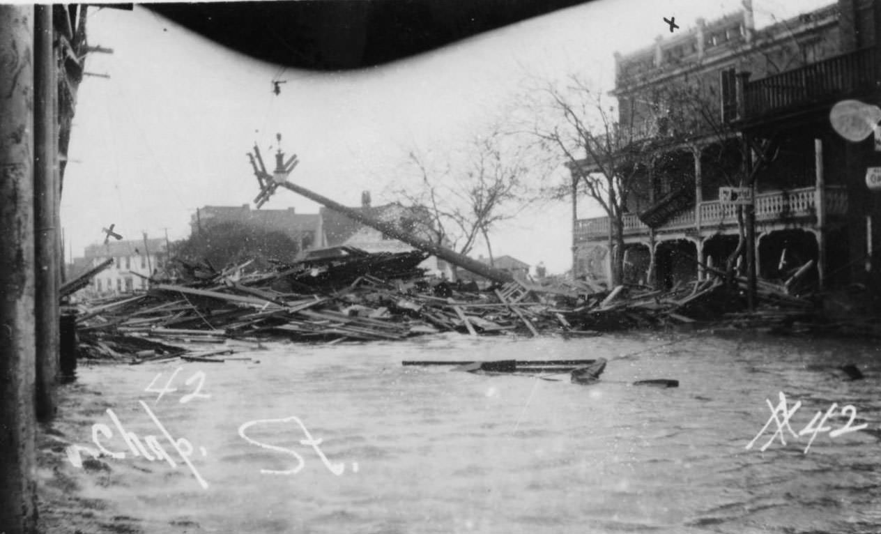 Chaparral Street, flooded with a large pile of debis. Plaza Hotel stands to the right.