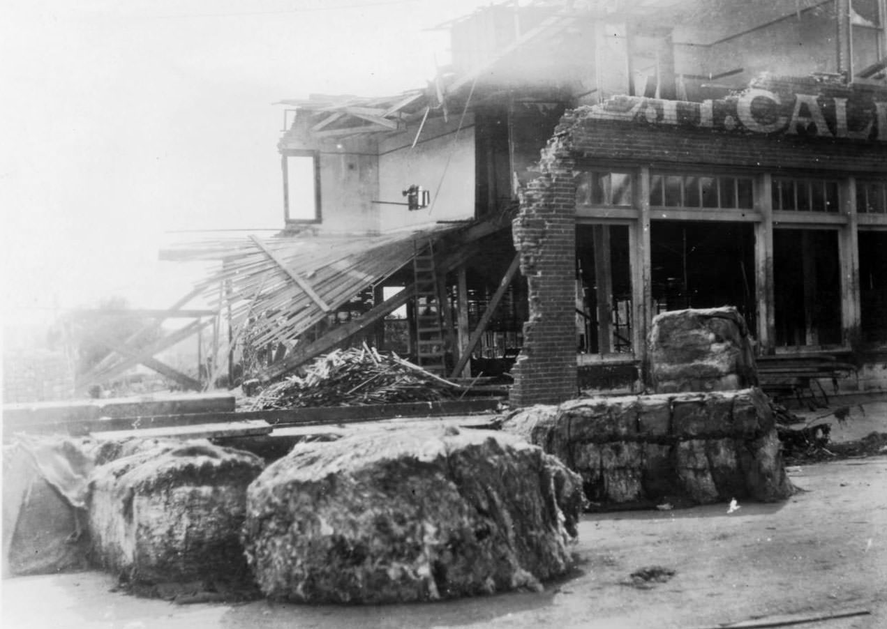 A heavily damaged hardware store after the 1919 hurricane in Corpus Christi. Brick walls have been demolished by the storm.