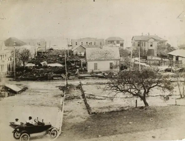 Storm debris is piled into the streets of downtown Corpus Christi following the hurricane of Sept. 14, 1919. This is Mesquite and William streets, looking toward the bay.