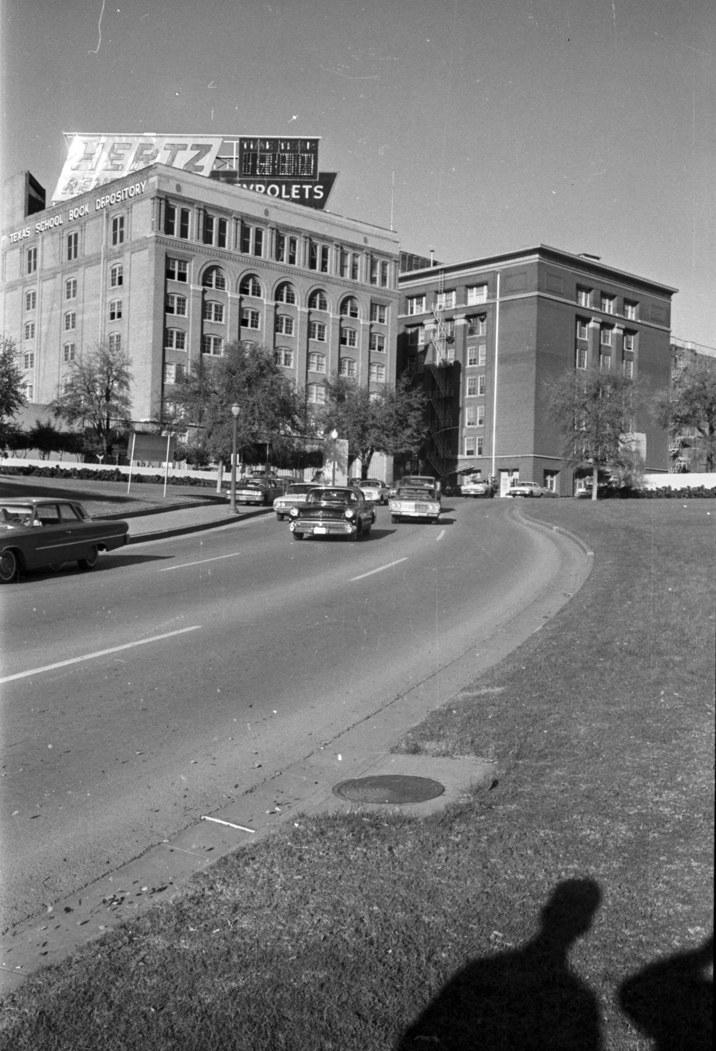 Looking northeast toward the Texas School Book Depository building following assassination of President John F. Kennedy, 1963