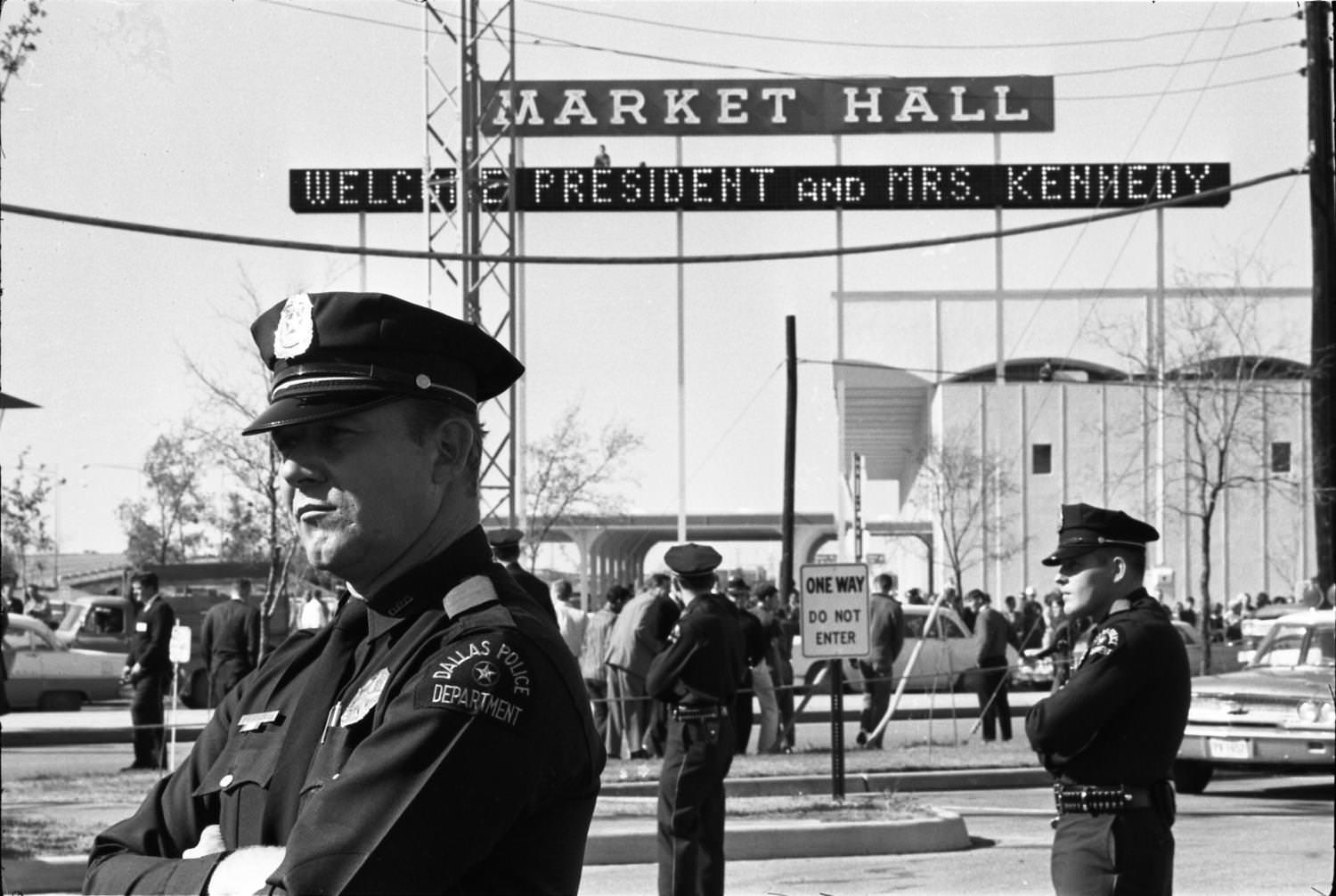 Dallas Police officers standing guard outside the Dallas Trade Mart, 1963