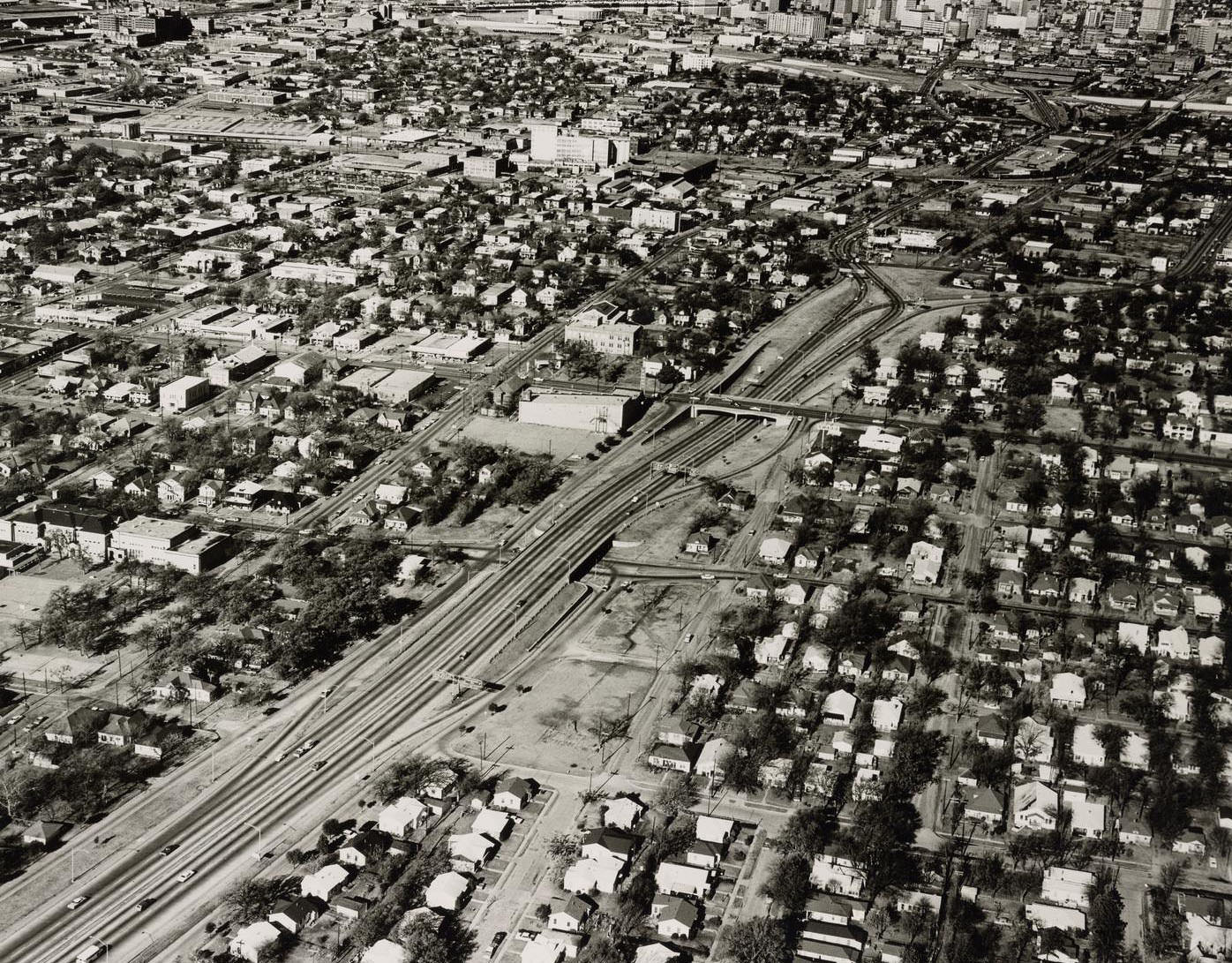 Af an aerial overview of Kimble Park and the surrounding neighborhoods and downtown Dallas, 1966