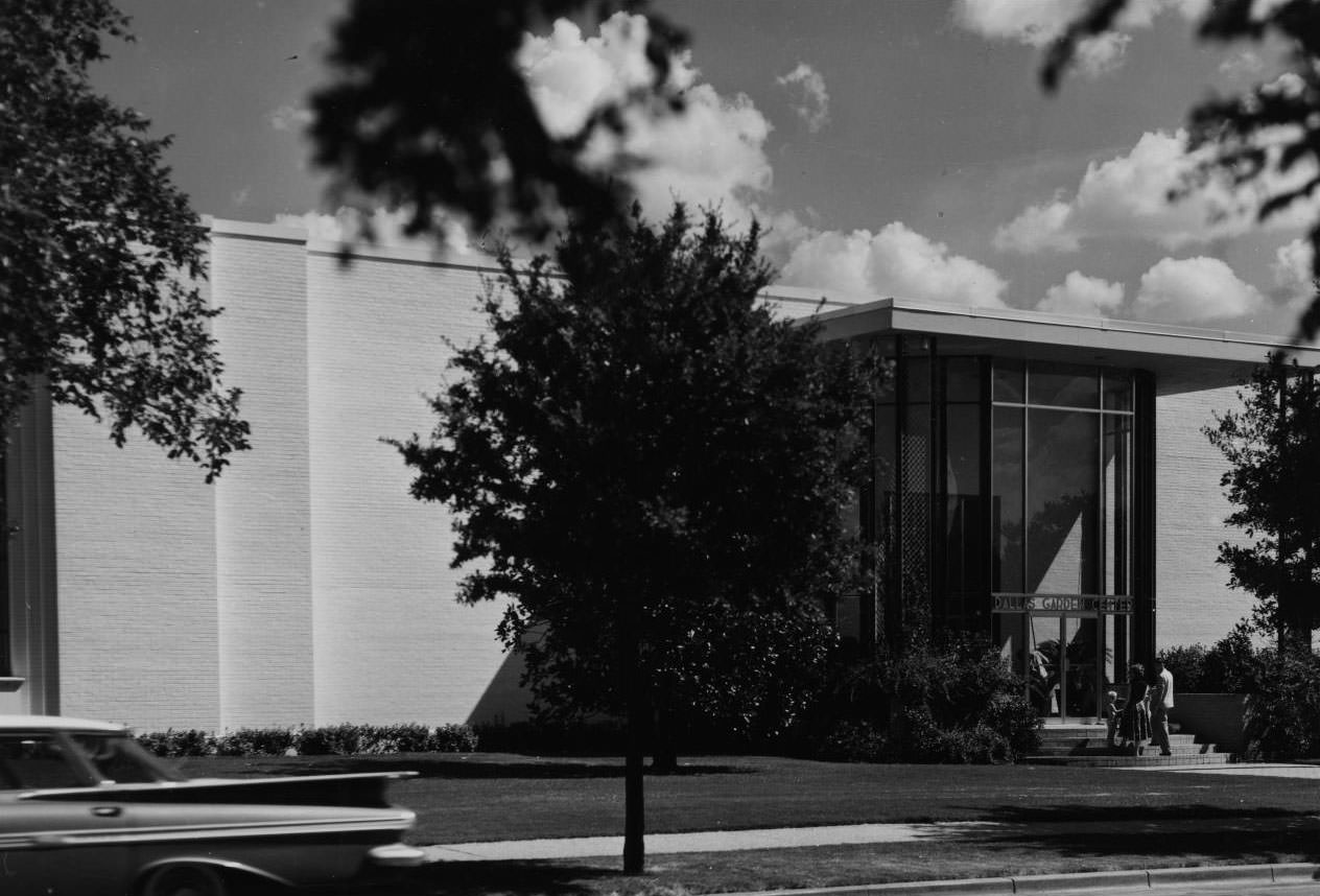 Tall glass entrance with two doors and a sign above them that reads "Dallas Garden Center', 1968