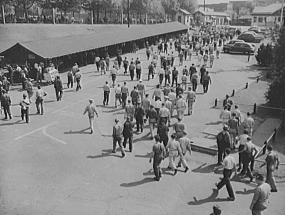 Workers are leaving the gates of the yard, after their regular shift, 1941