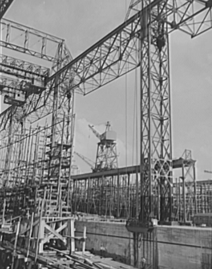 Thousands of tons of lumber and steel are used in the construction of these ways, where American mechanical genius is employed in the production of ships for our new two-ocean navy, 1941