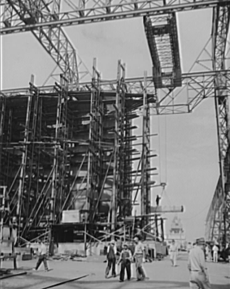 Shipbuilding in Newport News. Through the scaffolding may be seen the prow of a battleship under construction, 1941