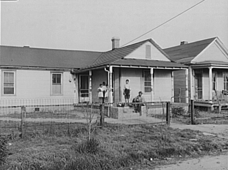 Shipyard worker shown at his rural home with four of his children, 1942