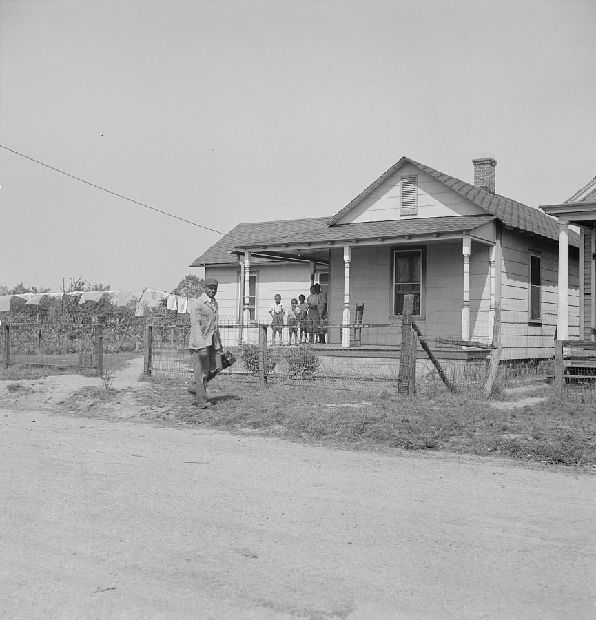 Shipyard worker leaving his rural home for the shipyards with his lunch box, 1942