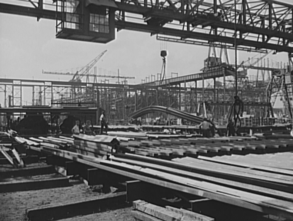 In the foreground is the frame section for a new naval vessel under construction. The ways and overhead carriers and cranes are seen in the background, 1941