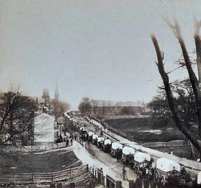 The first Union wagon train entering Petersburg, Virginia, with provisions after the Rebels were forced to evacuate, 1865