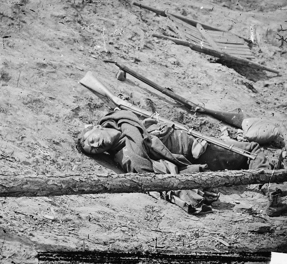 Dead Confederate soldier with gun, Petersburg, 1865