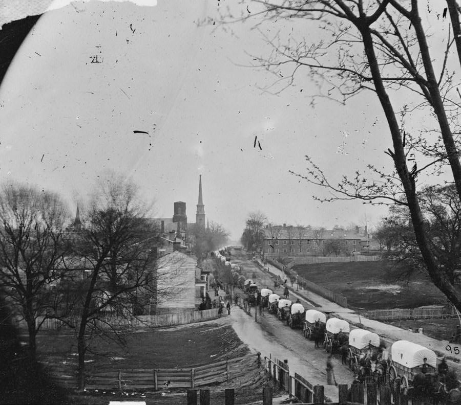 The first Federal wagon train entering the town, Petersburg, 1865