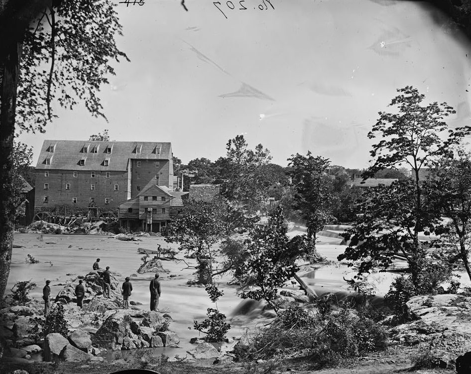 Johnson's Mill on the Appomattox near Campbell's Bridge; soldiers standing on rocks in the stream, 1865