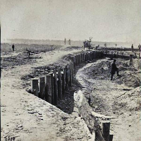 Rebel breastworks in front of Petersburgh (i.e. Petersburg). The small mounds with chimneys are the soldiers' quarters, under ground, 1865