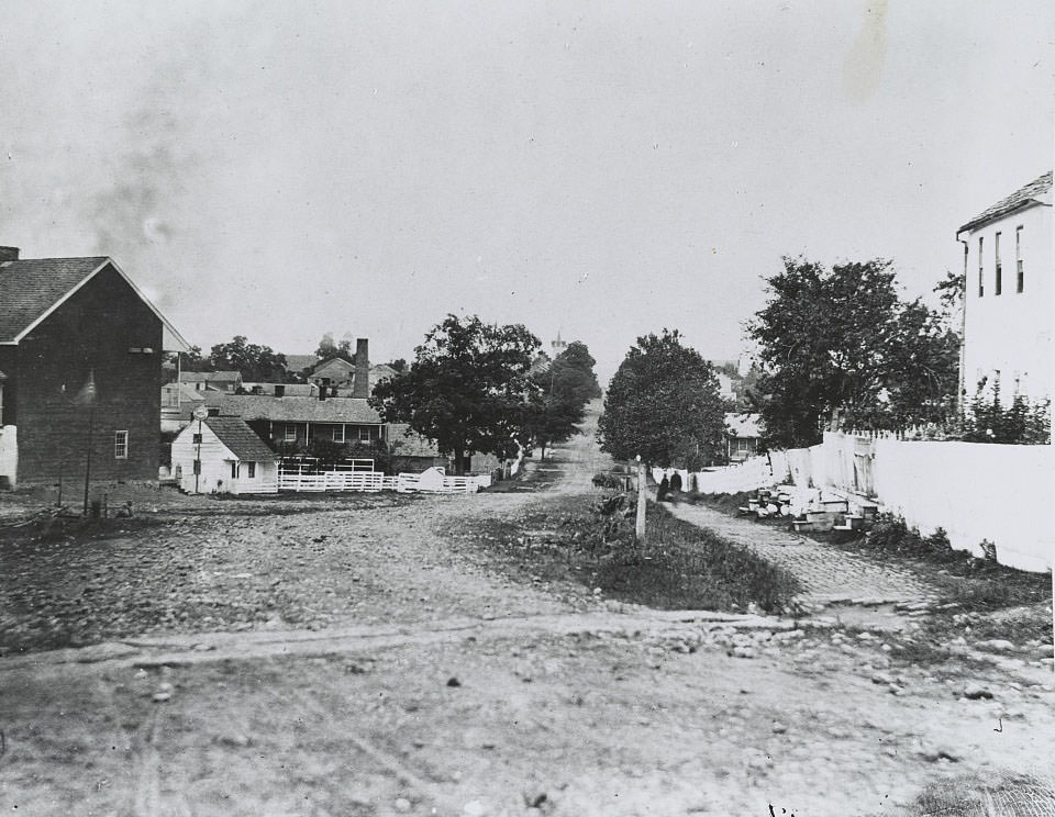 Homes along a dirt road. View may be of Gettysburg rather than Petersburg, 1865
