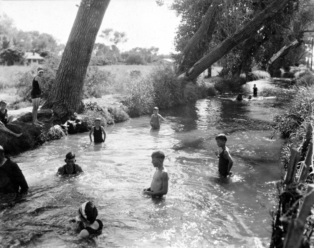 Swimming in the Town Ditch or Swilling's Ditch. It ran to Van Buren Street in the old townsite but was paved over by the 1930s.