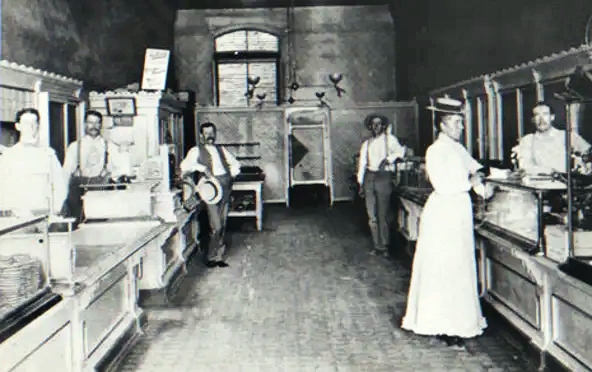 Inside the Holsum Bakery in Phoenix, circa 1890. Standing center left is Ed Eisele, founder, who purchased Phoenix Bakery in 1884 and center right, Alfred Becker who became his partner shortly after.