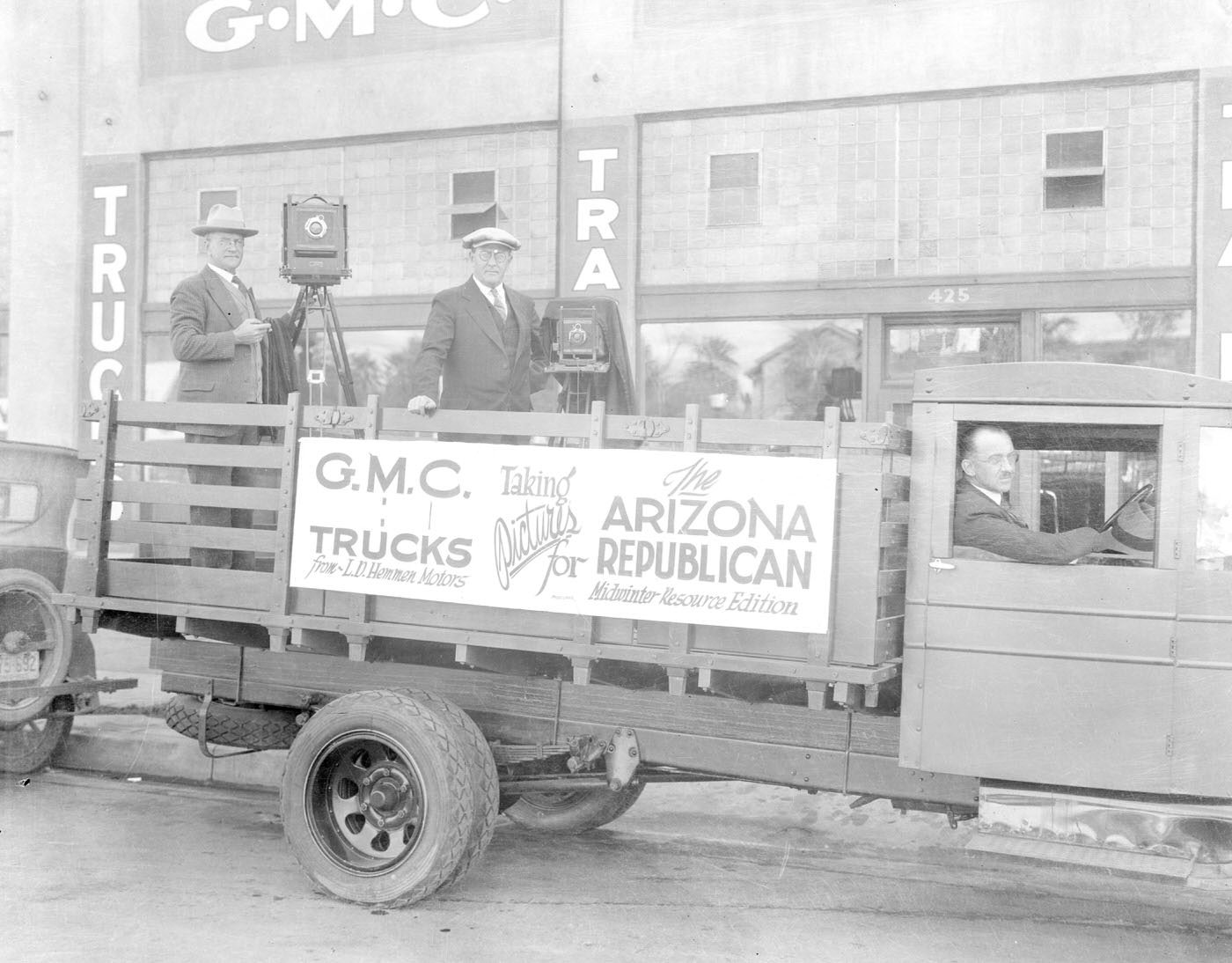 Will and James McCulloch on Flatbed Truck During Midwinter Carnival, 1900s