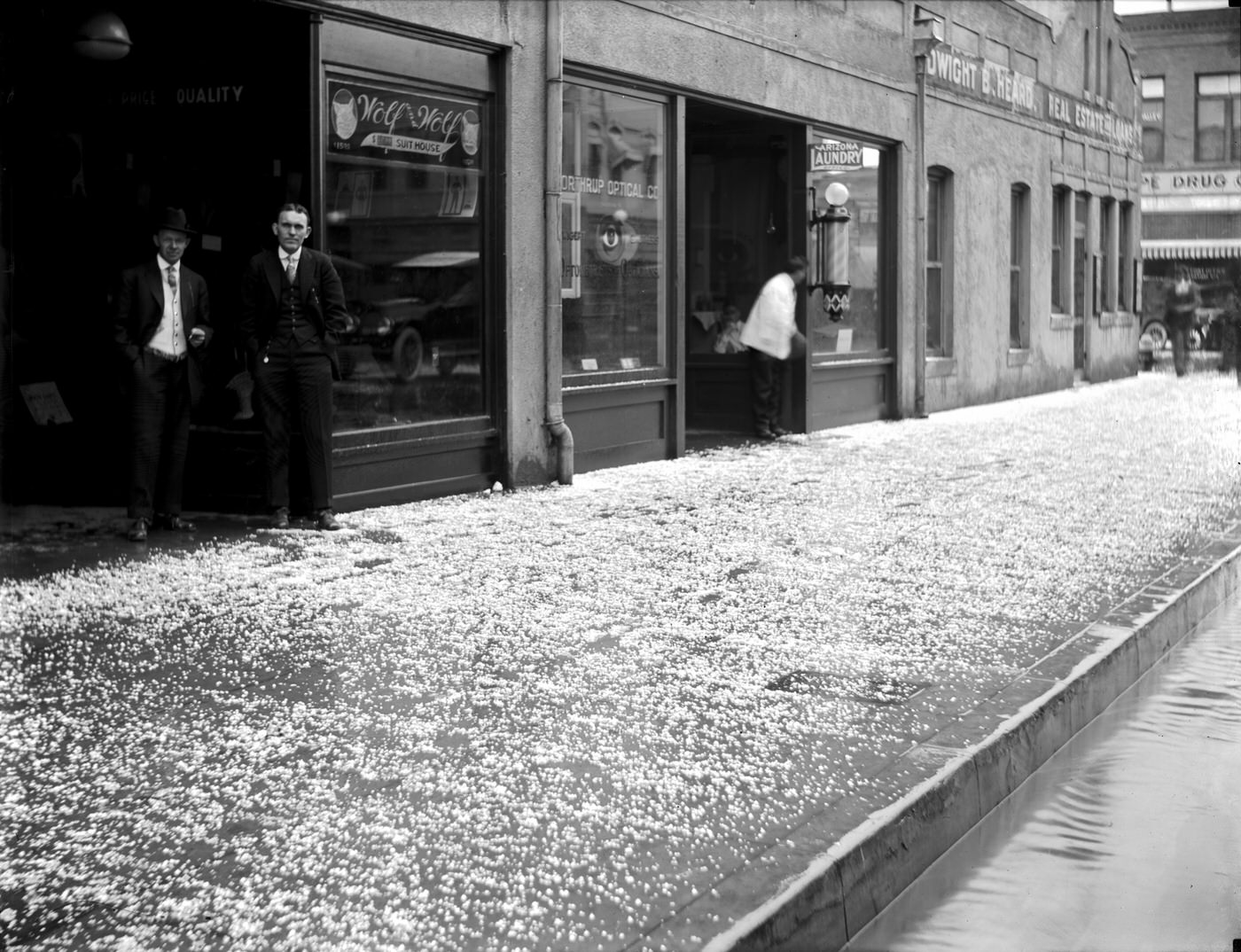 Hail on Sidewalk in Front of Shops on E. Adams Street, 1917